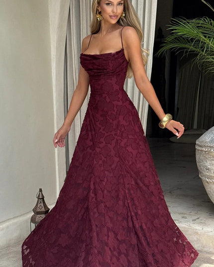 Women's burgundy floral jacquard maxi dress with a slight twirl, showcasing the movement and drape of the fabric.