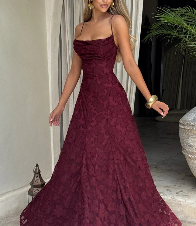 Women's burgundy floral jacquard maxi dress with a slight twirl, showcasing the movement and drape of the fabric.