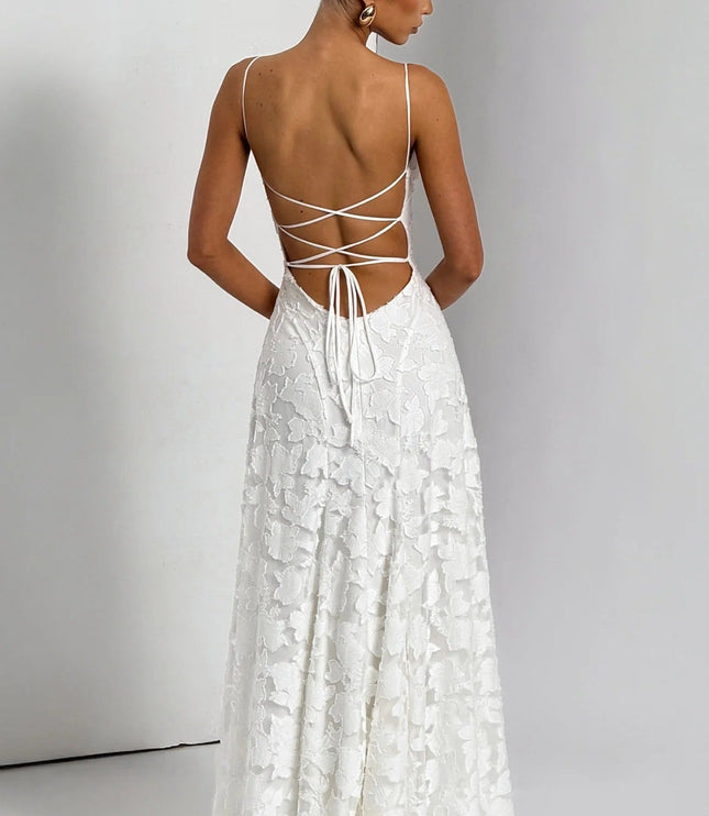 Back view of a women's white floral jacquard maxi dress, displaying the intricate lace-up back and flowing skirt.