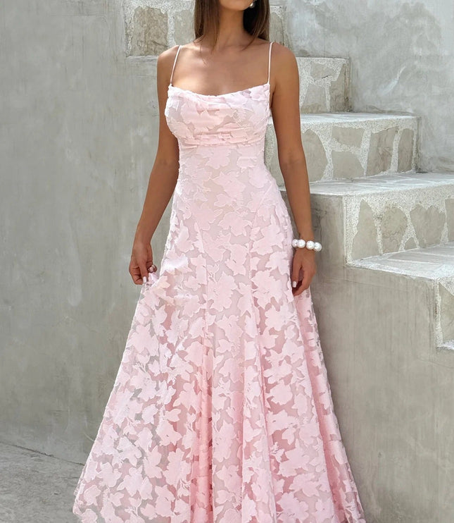 Full-length women's pink floral jacquard maxi dress with delicate spaghetti straps and a flowing skirt, for a special occasion.