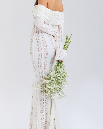 Back view of the white floral lace off-shoulder long sleeve maxi dress, with a subtle train and bell sleeves.