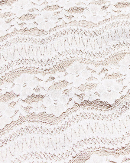 Close-up texture of the white floral lace fabric used for the off-shoulder long sleeve maxi dress.