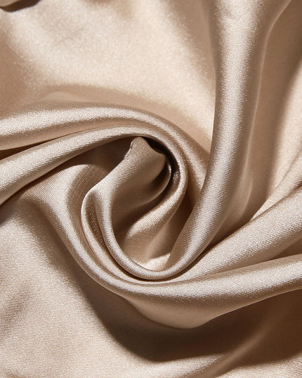 Close-up texture of the champagne-colored satin lining fabric, showing its smooth and shiny finish.
