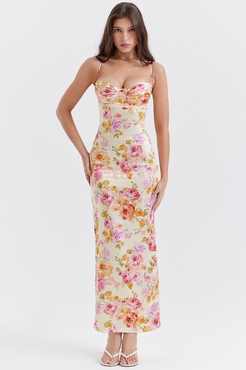 Full length view of a women's floral maxi dress with sweetheart neckline and delicate lace trim, hands on hips.