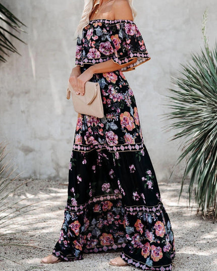 Side view of a black floral off-shoulder maxi dress, featuring pink and orange flowers and a tiered silhouette.