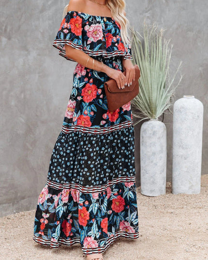 Women's black off-shoulder ruffled maxi dress with bold red and pink floral patterns, blue accents, and striped trim.