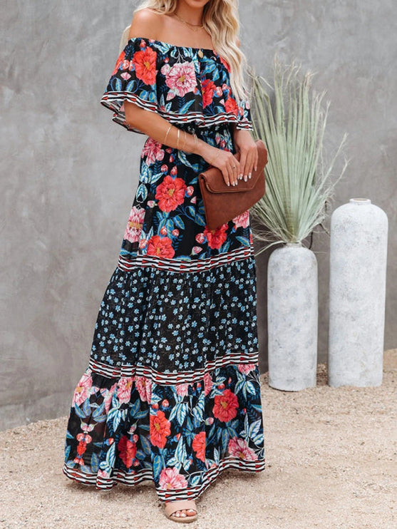 Women's black off-shoulder ruffled maxi dress with bold red and pink floral patterns, blue accents, and striped trim.