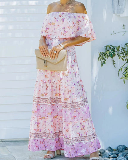 Front view of a light pink floral off-shoulder ruffled maxi dress with a tiered skirt and intricate patterns.