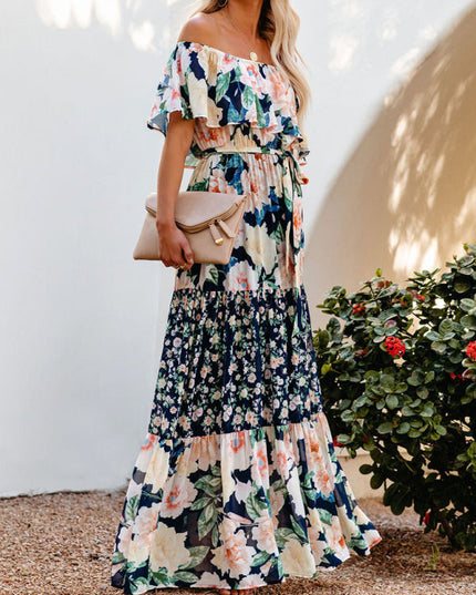 Front view of the women's off-shoulder ruffled floral maxi dress, featuring the navy blue, peach, and cream floral pattern.