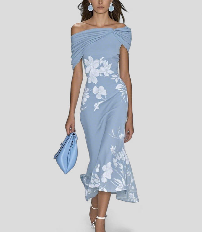 Light blue off-shoulder midi dress with white floral print and elegant trumpet hem, holding a blue handbag.