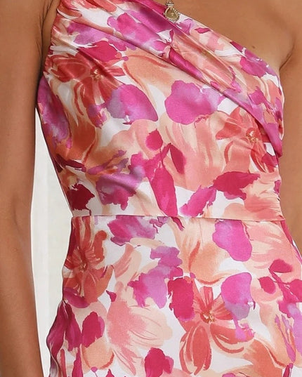 Close-up of the ruched bust and one-shoulder detail on a pink and fuchsia floral midi dress for women.