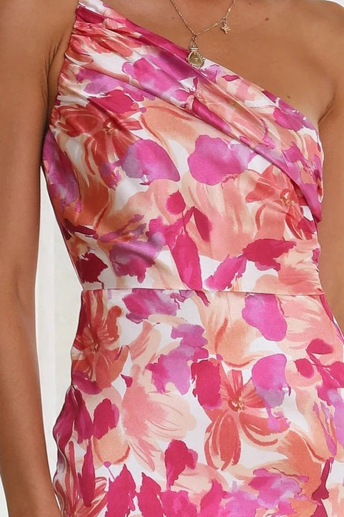 Close-up of the ruched bust and one-shoulder detail on a pink and fuchsia floral midi dress for women.