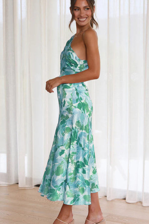 Side profile of women's floral one shoulder ruched bust midi dress in green and light blue.