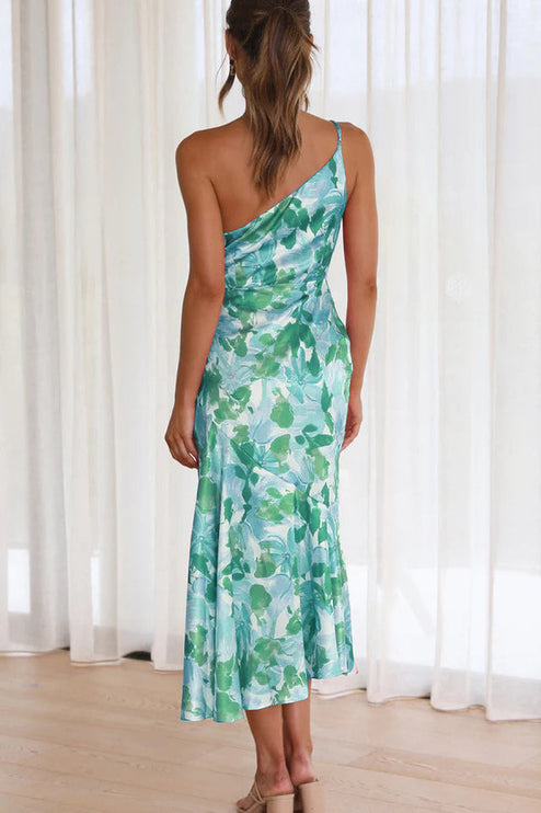 Back view of women's floral one shoulder midi dress in green and light blue with ruched bust.