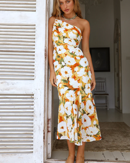 Women's floral one-shoulder midi dress, white base with vibrant orange and green floral pattern, elegant fit.