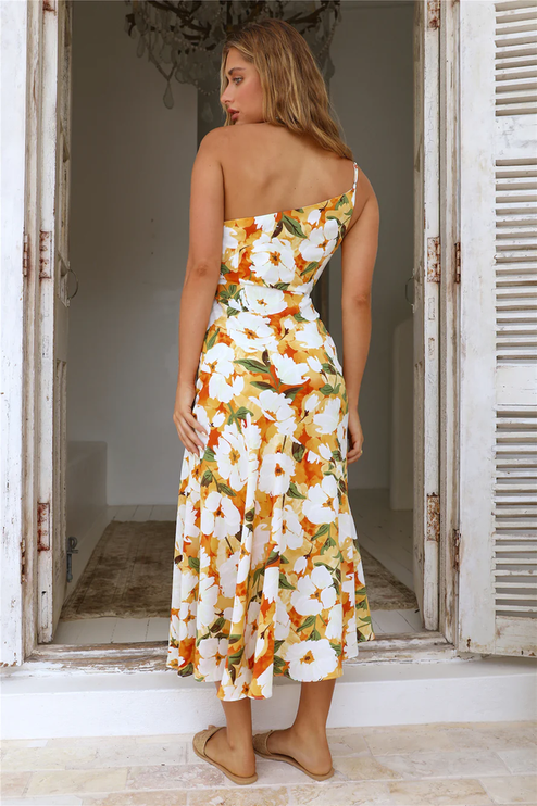 Back view of women's floral one-shoulder midi dress, white with orange and green flowers, showing strap detail.