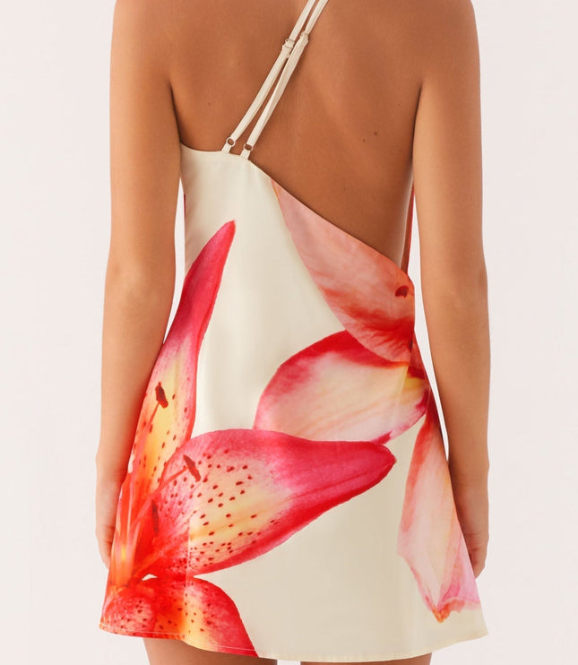 Back view of a women's floral print open back mini dress, showing the delicate straps and red and pink lily design.