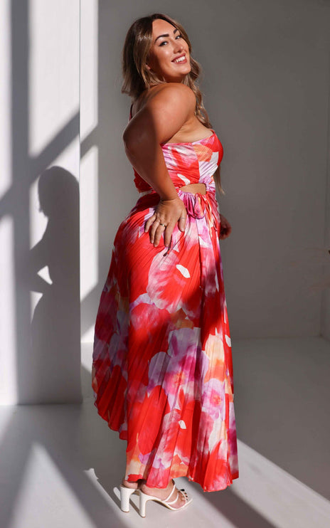 Side profile of women's floral print maxi dress, showing the one-shoulder design and subtle waist cut-out.