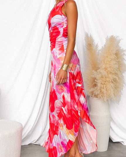 Side view of women's floral print one-shoulder maxi dress with a high-low hem and clear strap heels.