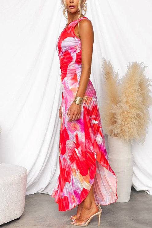 Side view of women's floral print one-shoulder maxi dress with a high-low hem and clear strap heels.