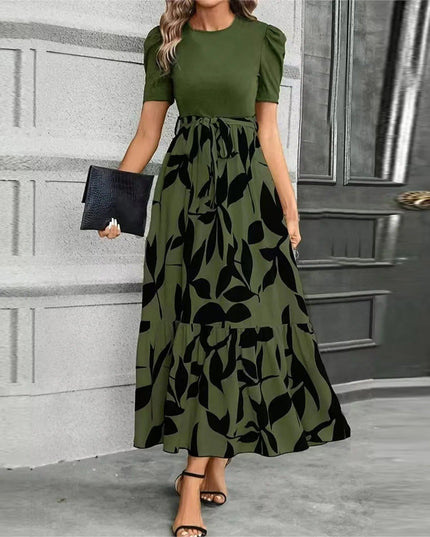 Women's olive green short sleeve top with a high waist maxi dress featuring a large black leaf print, tied at the waist.