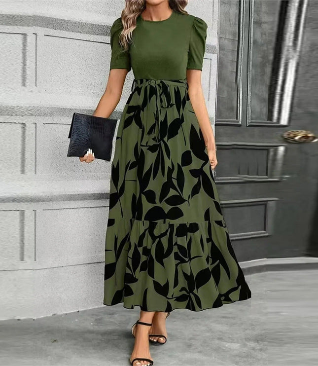 Women's olive green short sleeve top with a high waist maxi dress featuring a large black leaf print, tied at the waist.