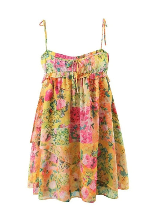Flat lay of the yellow floral print tie shoulder mini dress, showing the tiered ruffles and vibrant pattern.