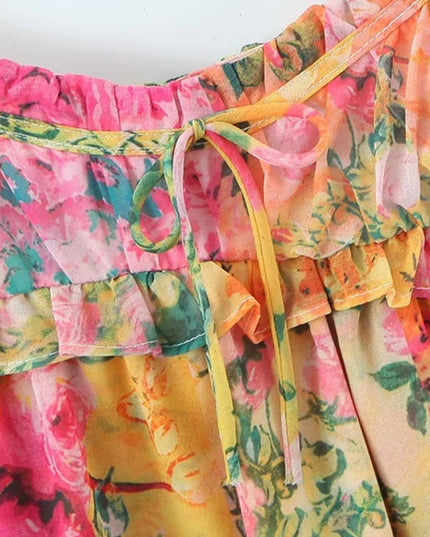 Close-up of the bodice of the floral print mini dress, highlighting the tie shoulder straps and ruffled neckline.
