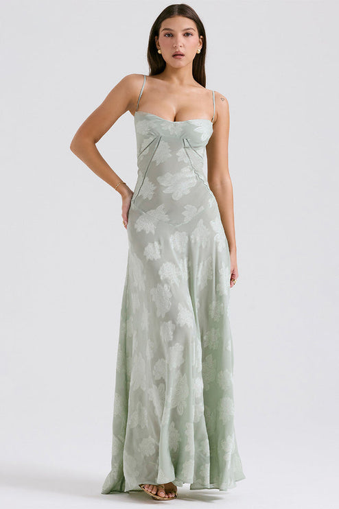 Full-length view of a women's floral printed sweetheart neck maxi dress in a soft sage green, with spaghetti straps.
