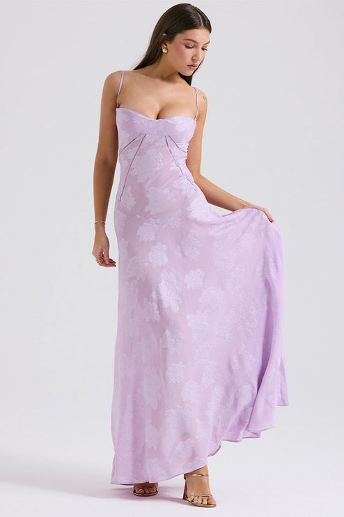 Women's light lavender floral printed maxi dress, showing the flowing skirt and sweetheart neckline, styled with gold heels.
