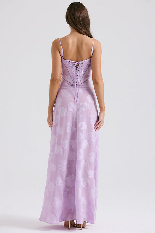 Back view of the women's floral printed maxi dress in lavender, featuring a corset-style lace-up back detail.
