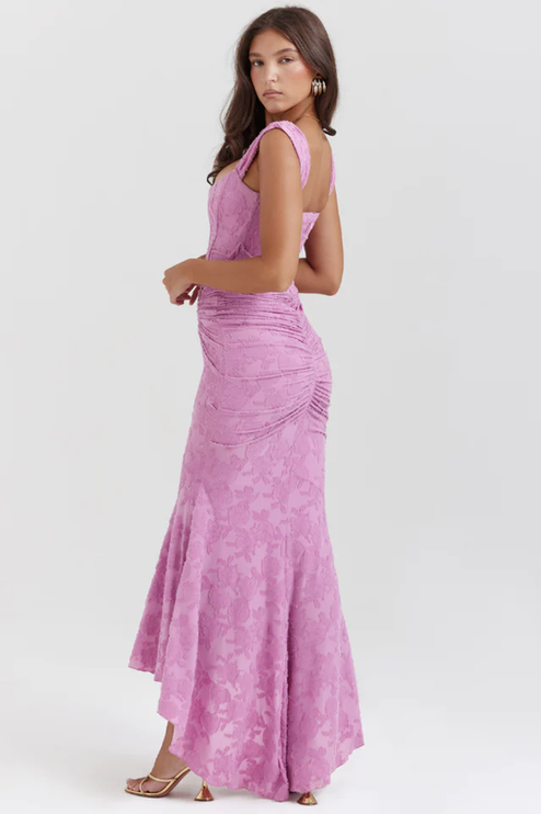 Rear side view of the pink floral ruched off-shoulder maxi dress, emphasizing the ruching on the back and high-low hem.