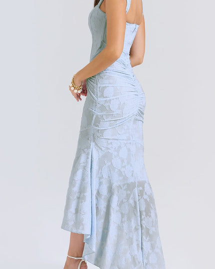 Three-quarter back view of the women's light blue floral ruched maxi dress, highlighting the fitted bodice and flowing skirt.