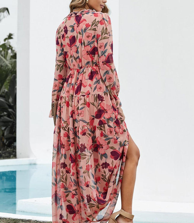 Back view of a women's pink floral long sleeve maxi dress with a ruffled V-neck and tiered skirt.