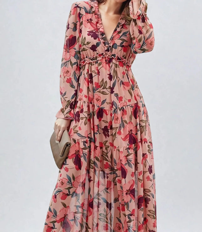 Women's pink floral long sleeve maxi dress with ruffles and a deep V-neck, holding a clutch.