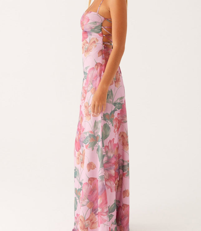 Side profile of a women's pink floral square neck maxi dress, showcasing the long, elegant silhouette.
