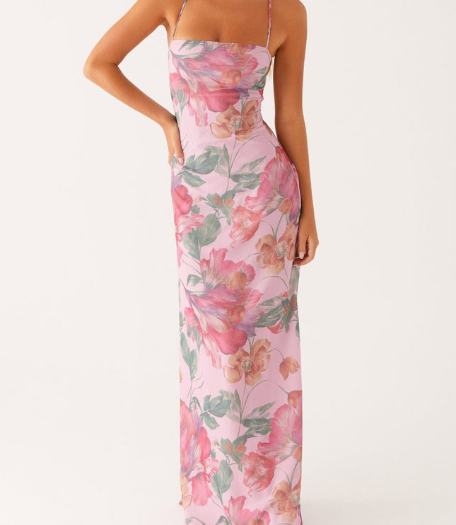 Front view of a women's pink floral square neck maxi dress with hands on hips, showing full length.