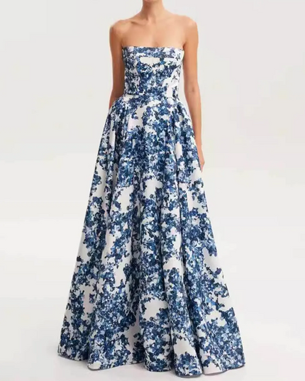 Front view of a women's formal strapless maxi dress featuring a bold blue floral pattern and a flowing skirt, for special occasions.