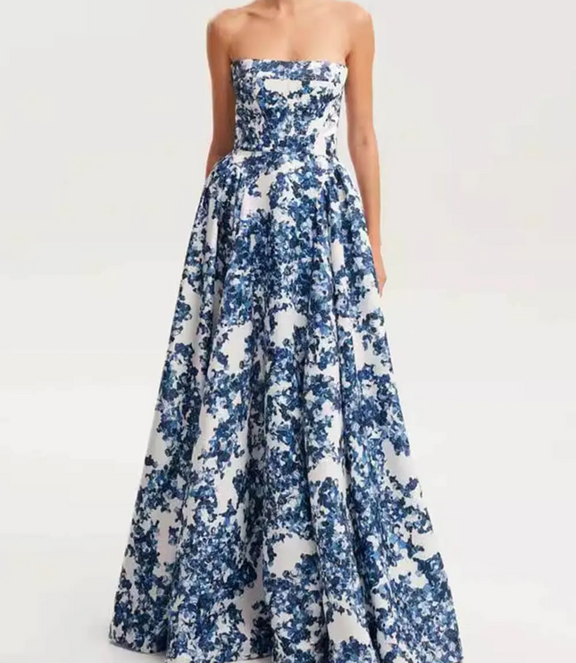 Front view of a women's formal strapless maxi dress featuring a bold blue floral pattern and a flowing skirt, for special occasions.