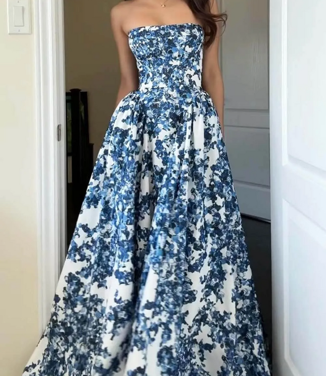 Front view of a women's strapless formal maxi dress in blue and white floral print, highlighting the dress's flowing fabric.