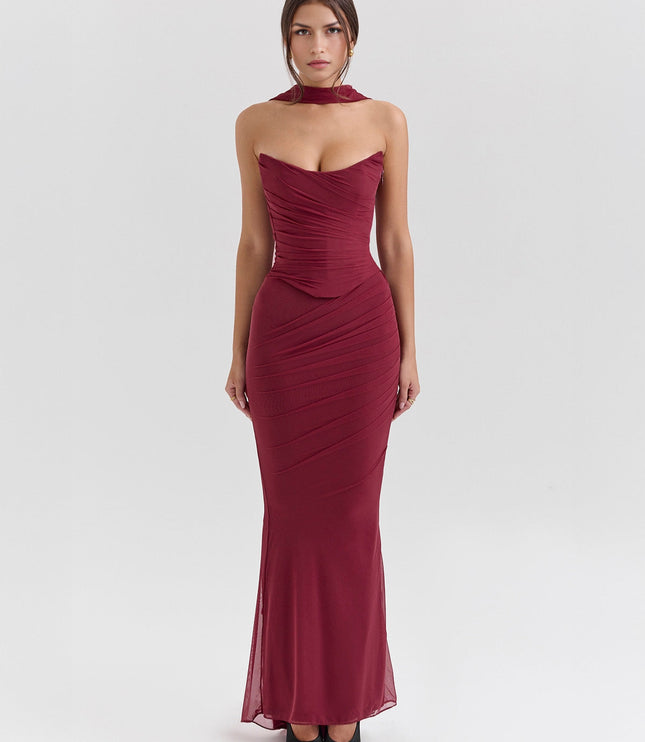 Full-length view of a deep red strapless ruched maxi dress, with a matching choker and elegant, fitted design.