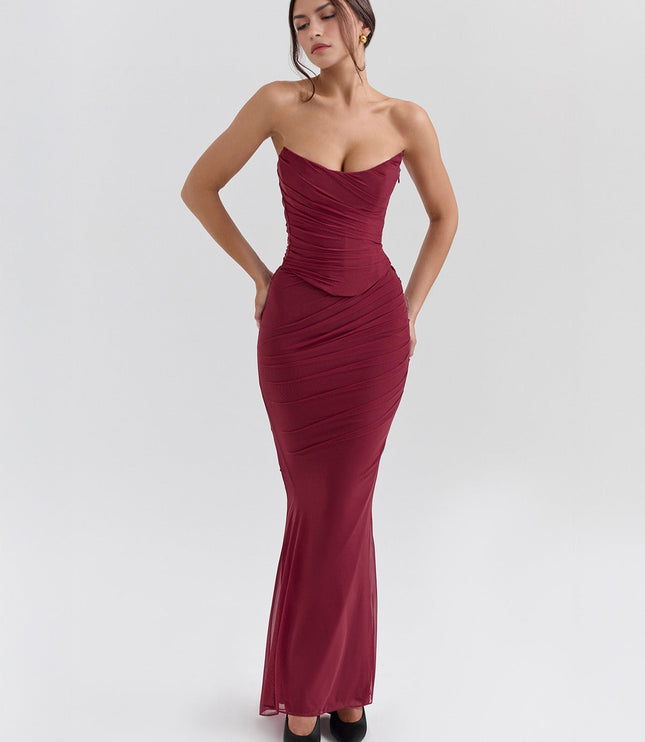 Front view of a deep red strapless ruched maxi dress, showcasing the fitted bodice and flowing sheer skirt.