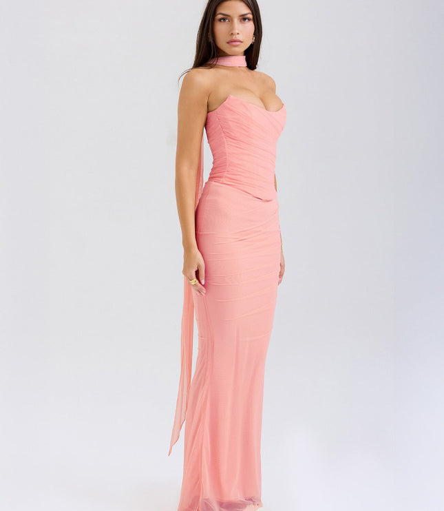 Side view of the light pink strapless ruched maxi dress, highlighting the long flowing sheer panel from the choker.