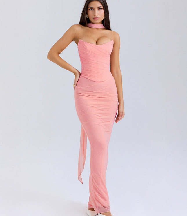 Front view of the light pink strapless ruched maxi dress, showing the corset-style bodice and white heels.