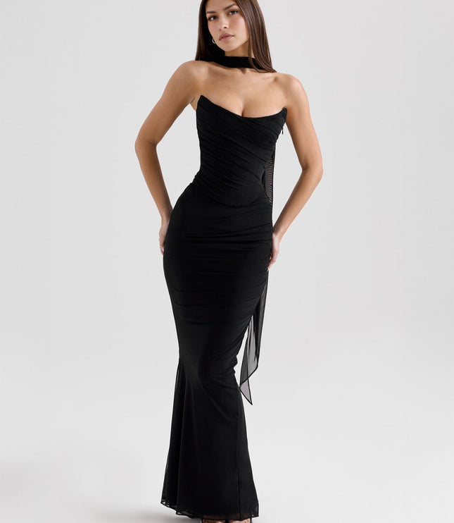 Black strapless ruched maxi dress, front angled view, showing sheer side panel and form-fitting style.