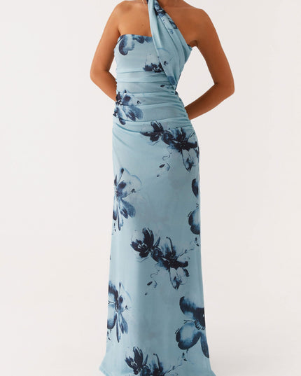 Full view of light blue floral strapless ruched maxi dress with an elegant draped neckline detail and dark blue flower pattern.