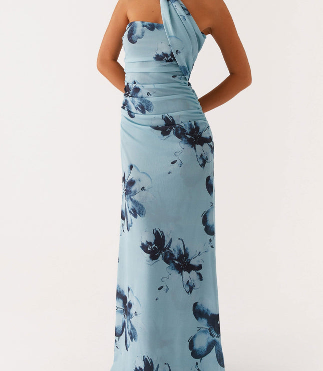 Full view of light blue floral strapless ruched maxi dress with an elegant draped neckline detail and dark blue flower pattern.