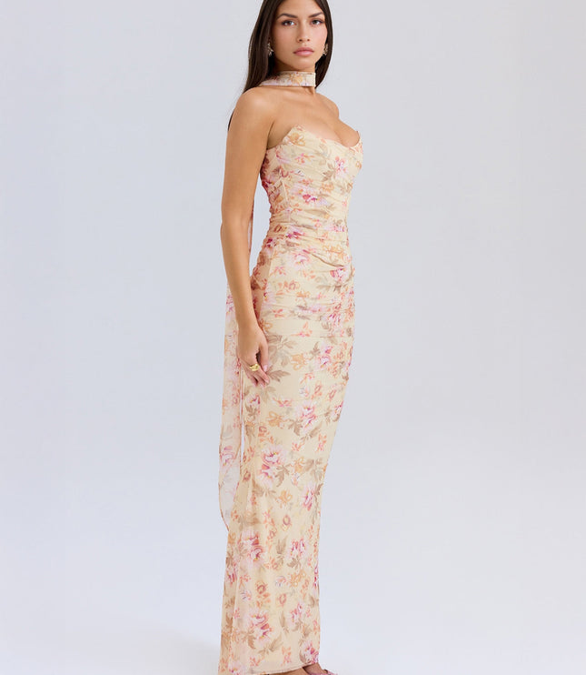 Side profile of the women's floral strapless ruched maxi dress, showcasing the floor-length skirt and ruched bodice detail.