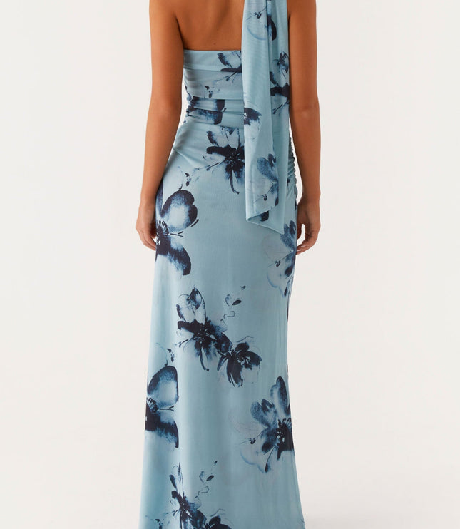 Back view of the light blue floral strapless ruched maxi dress, highlighting the back and the draped fabric detail.