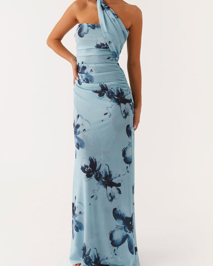 Light blue floral strapless ruched maxi dress with a hand on hip pose, emphasizing the fit and dark blue flower print.